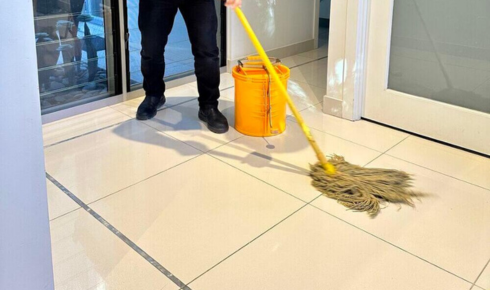 How can assigning different days for specific tasks, like glass or bathrooms, stop cleaning feeling overwhelming